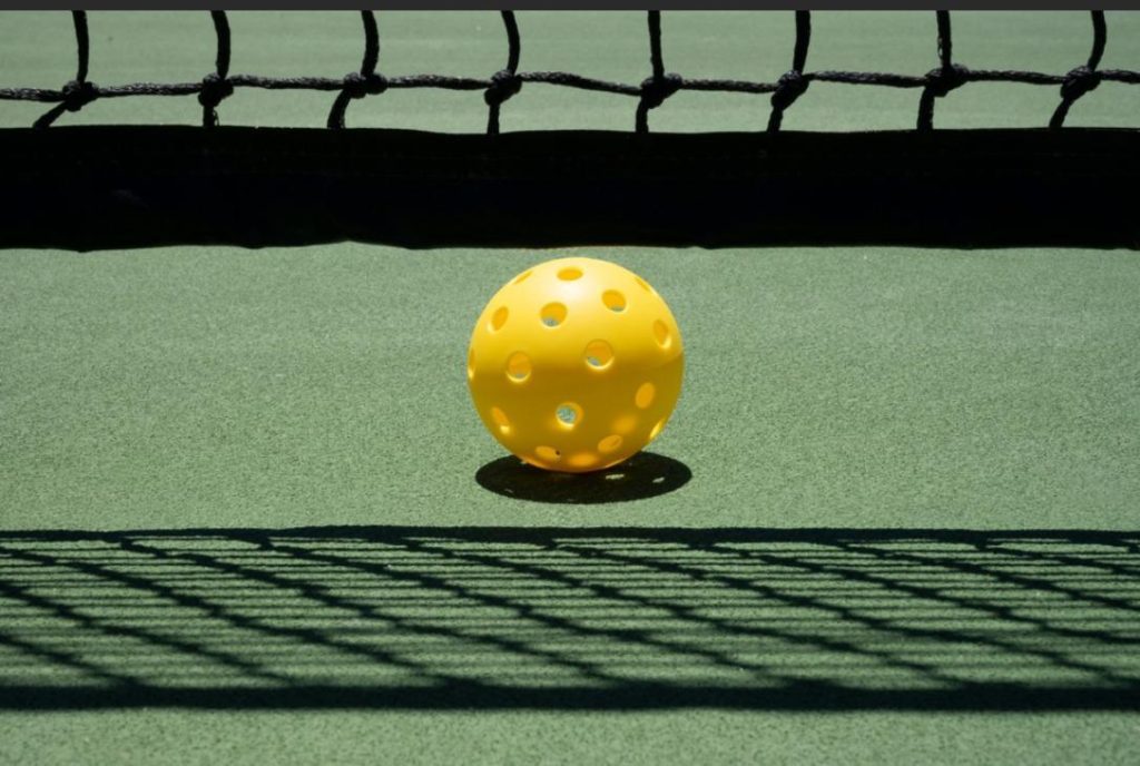 Pickleball Singles Strategy - a pickleball is placed near the net 1024x688