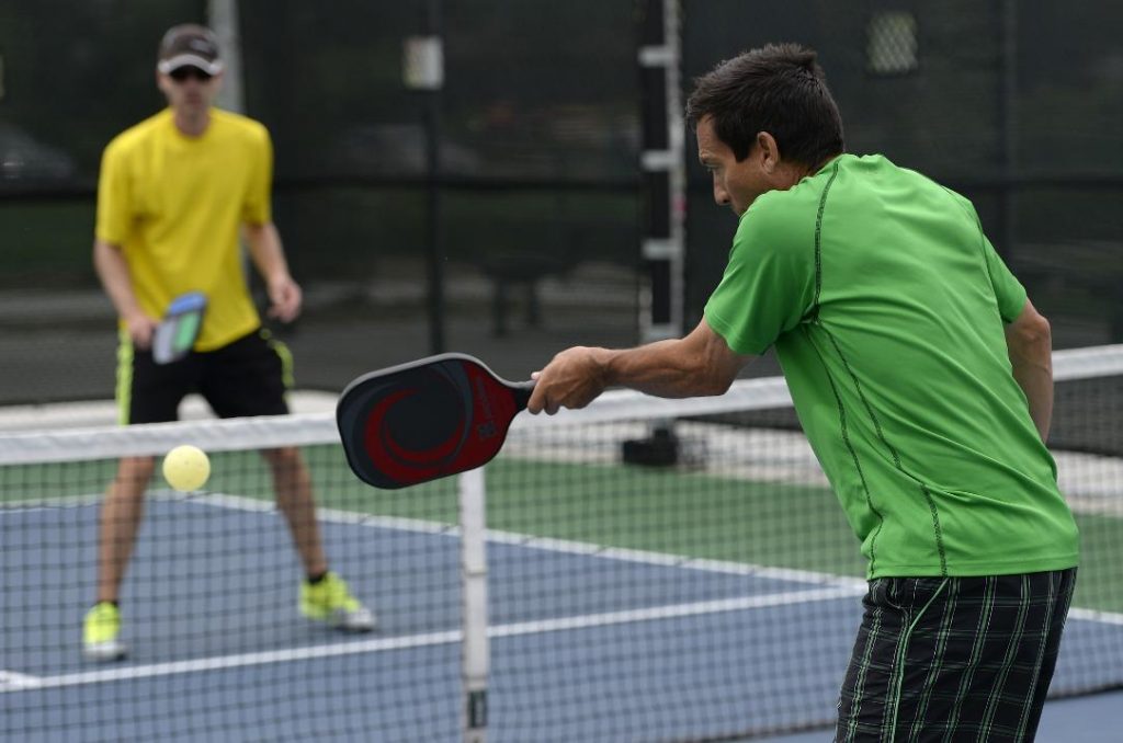 Pickleball Strategy: Tips & Techniques to Win - a player is assuming the behavior of the opponent while he is serving in a pickleball match 1024x678
