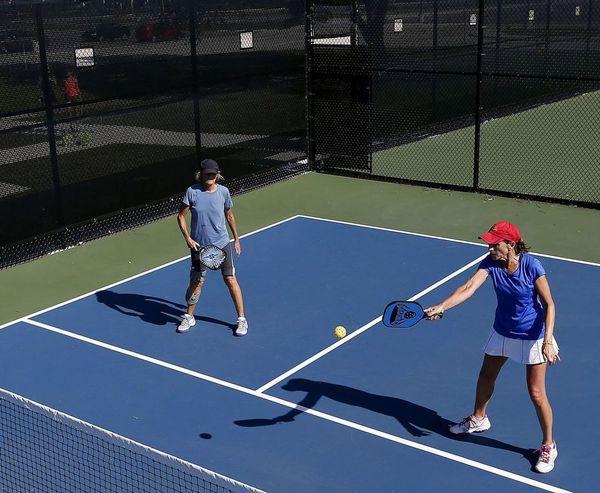 Doubles Pickleball Strategy - a player is standing near the non volley line in pickleball court